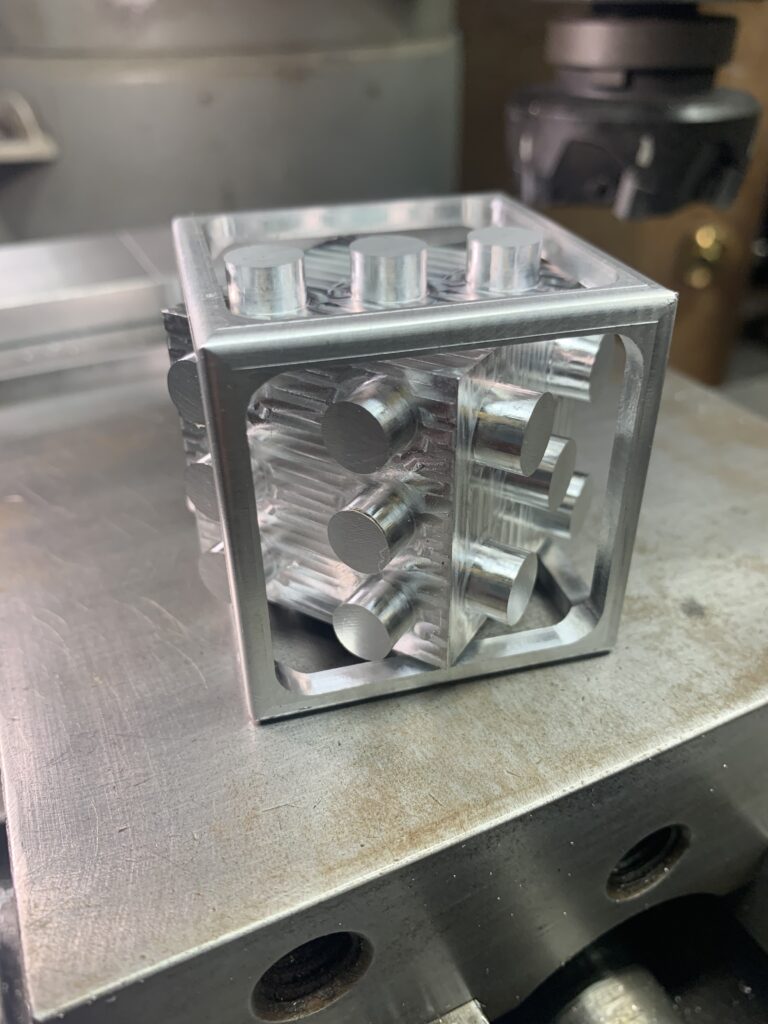 Precision CNC milled aluminum puzzle block with interlocking pins