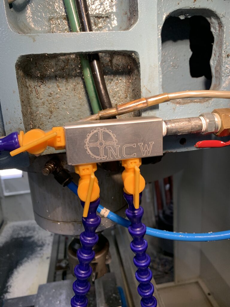 Nitro Custom Works branded coolant manifold mounted on a CNC mill in the South Jersey shop