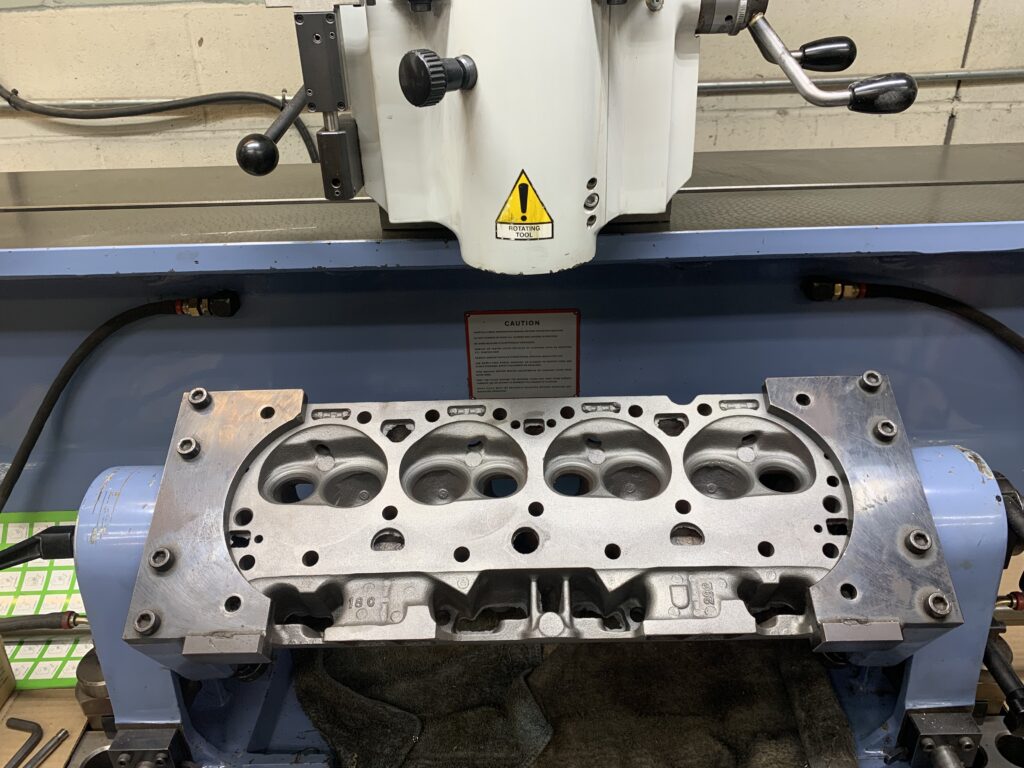 Cylinder head mounted on a milling machine for machining at Nitro Custom Works